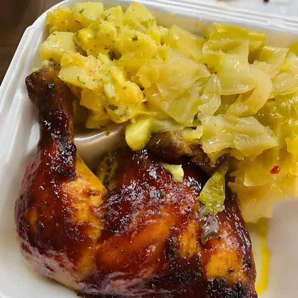 Ramzys Meat & Three's southern meal with glazed chicken, potato salad, and stewed cabbage.
